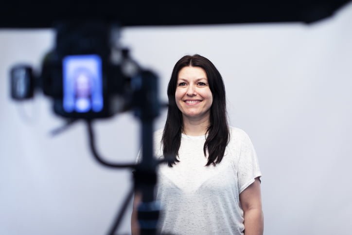 At the photo studio a model is posing for a photograph